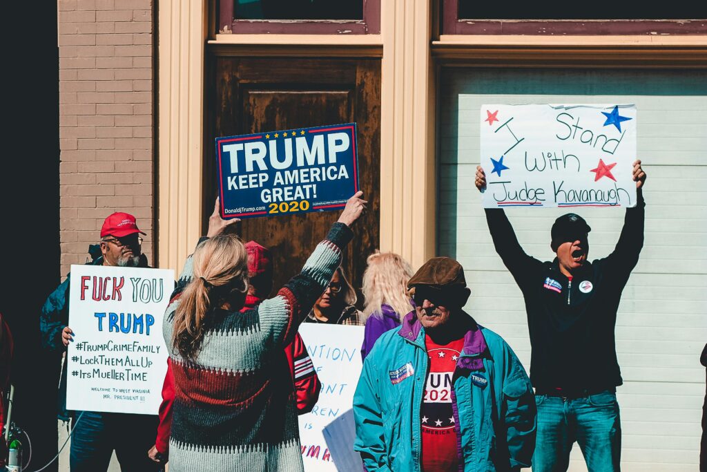 Various proponents and opponents of Trump with their respective signs.