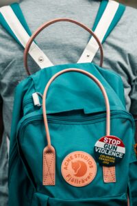 Stop gun violence during badge on a blue backpack bag